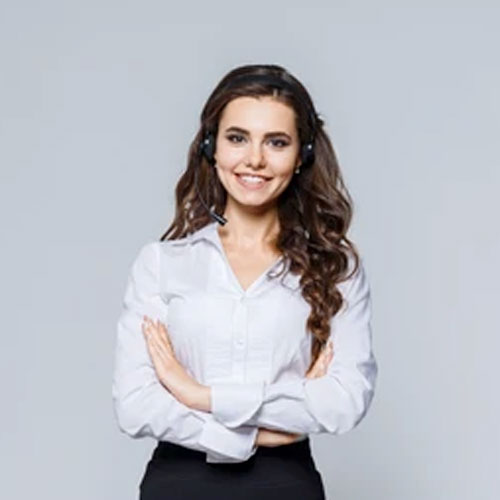 Gabby McKenzie, a dedicated service advisor at The Post Hole Company, stands before a grey backdrop, dressed in professional attire comprising of a crisp white blouse and a sleek black skirt. With a headset in place, she's poised to assist clients, embodying efficiency and expertise in customer service.